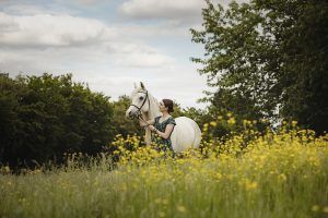 Yellow summer flowers in this milton Keynes field is the setting for this equestrian and her pony