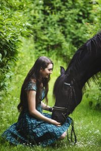 Girl kneels in front of her pony who leans into her in this Buckinghamshire portrait