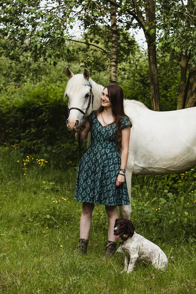 Milton Keynes field is the backdrop for this girl and her pony with the family dog at her feet