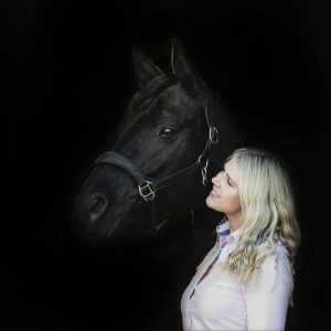 Dressage rider looks adoringly at her horse