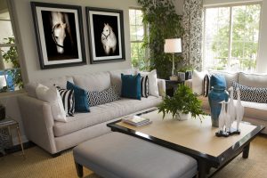 Living room with two photographs of grey horse on a black background, framed and hanging on the wall