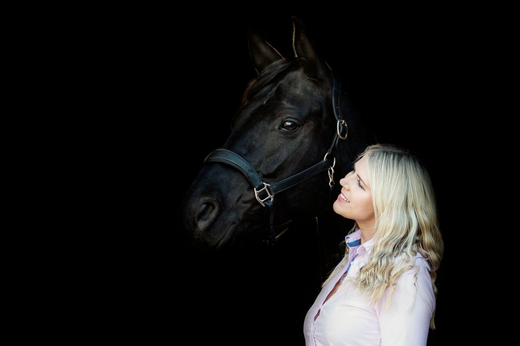 Buckinghamshire barn was the setting for this black background portrait of dressage rider and her horse